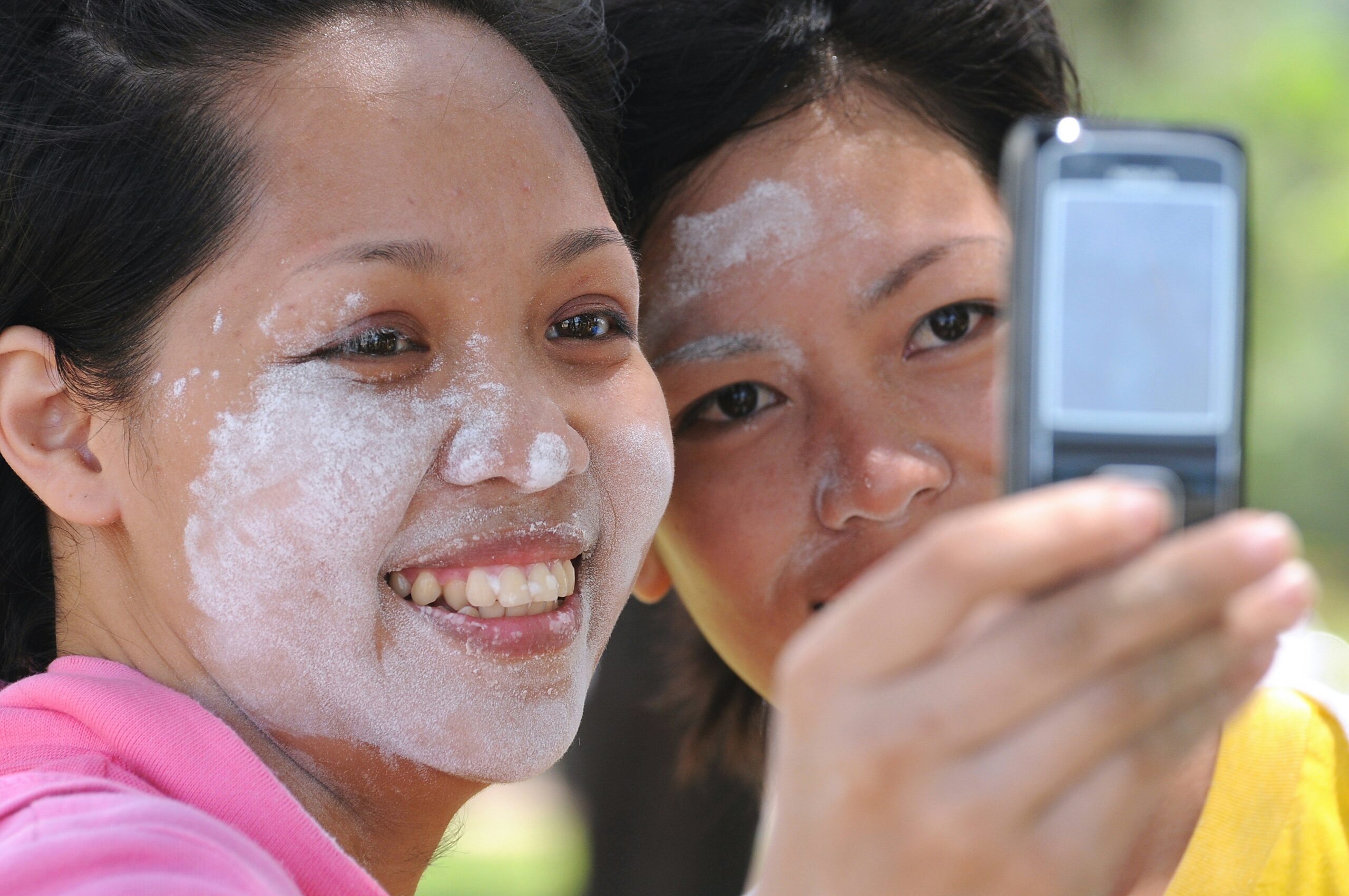 Close-up of someone reading ingredient label on jar of organic face cream