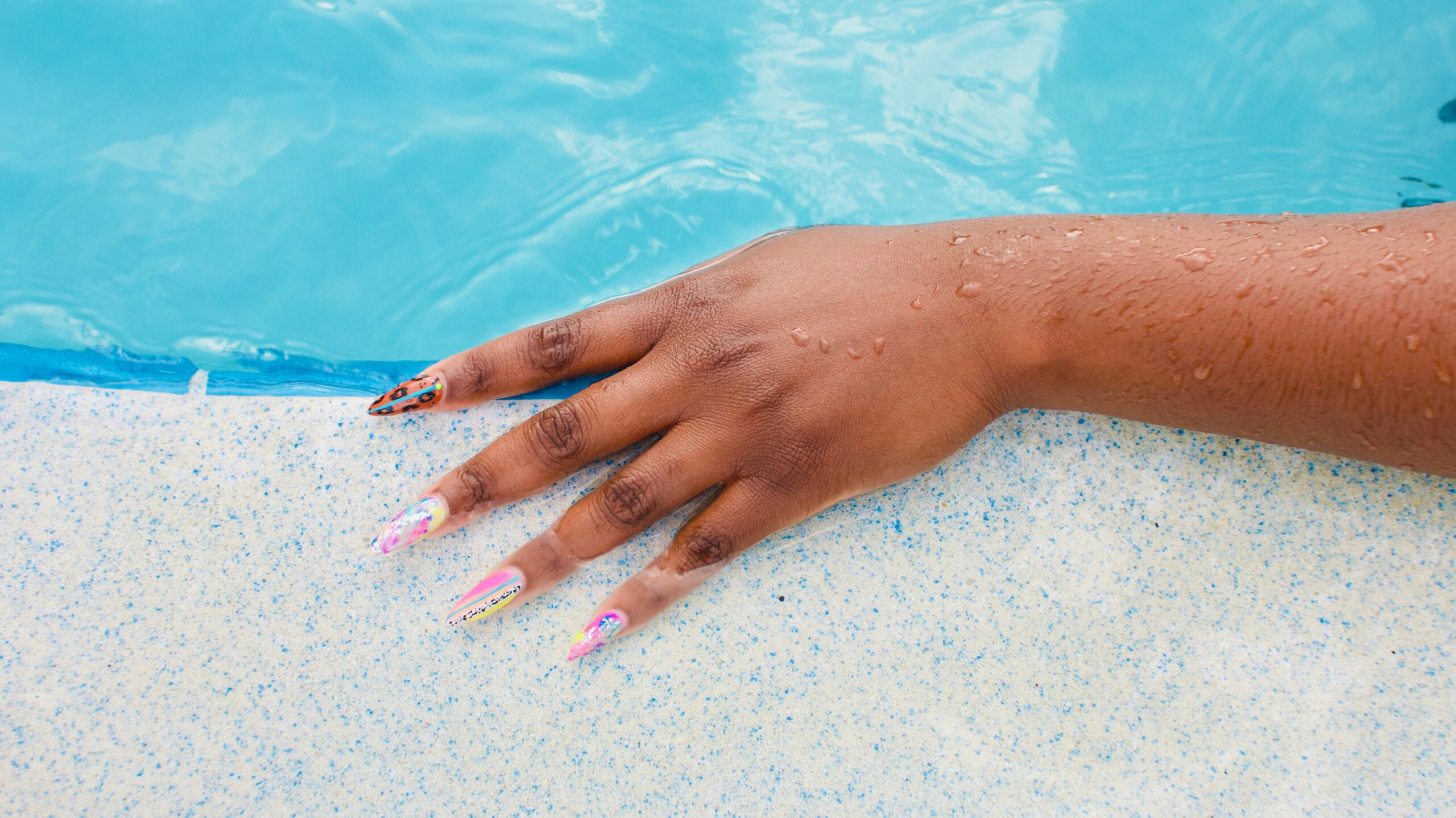 Close-up shot of hands gently massaging lotion onto skin