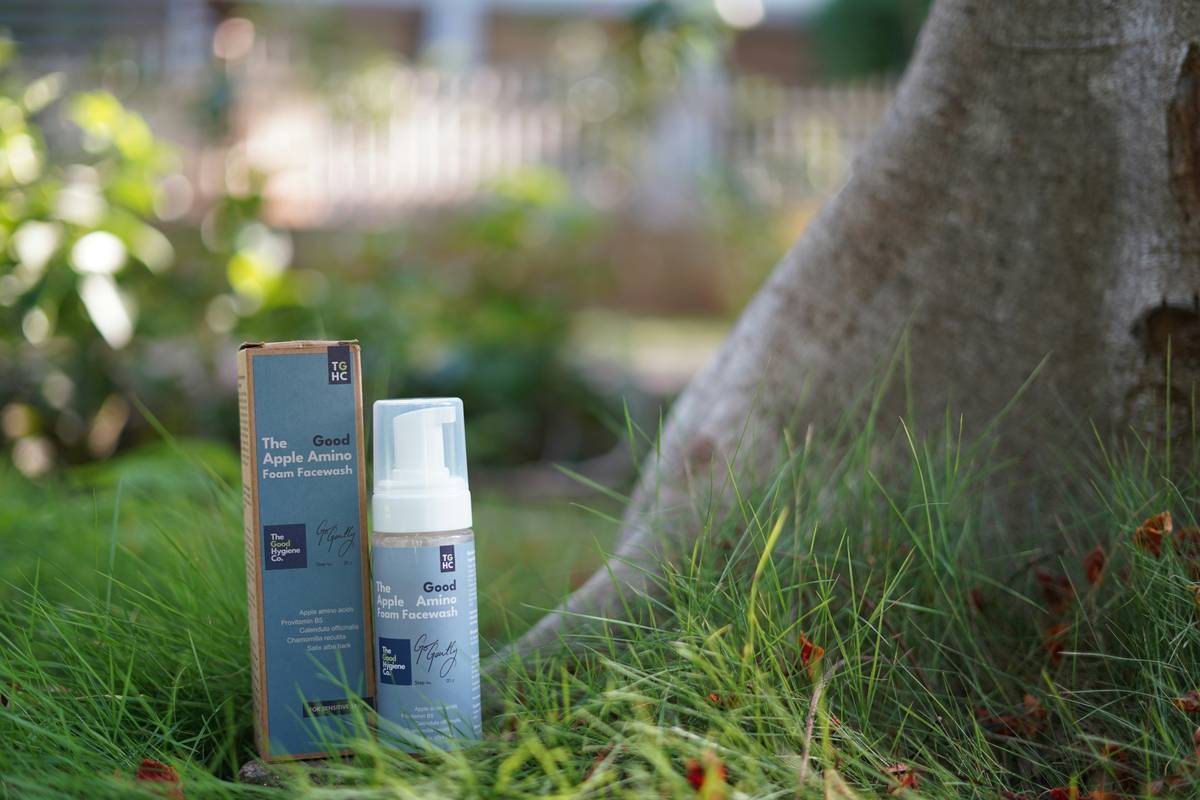 Eco-safe moisturizer bottles next to fresh plants