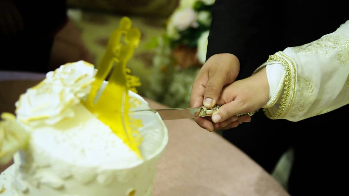 A close-up image of a creamy floral moisturizing lotion with visible petals inside the jar.