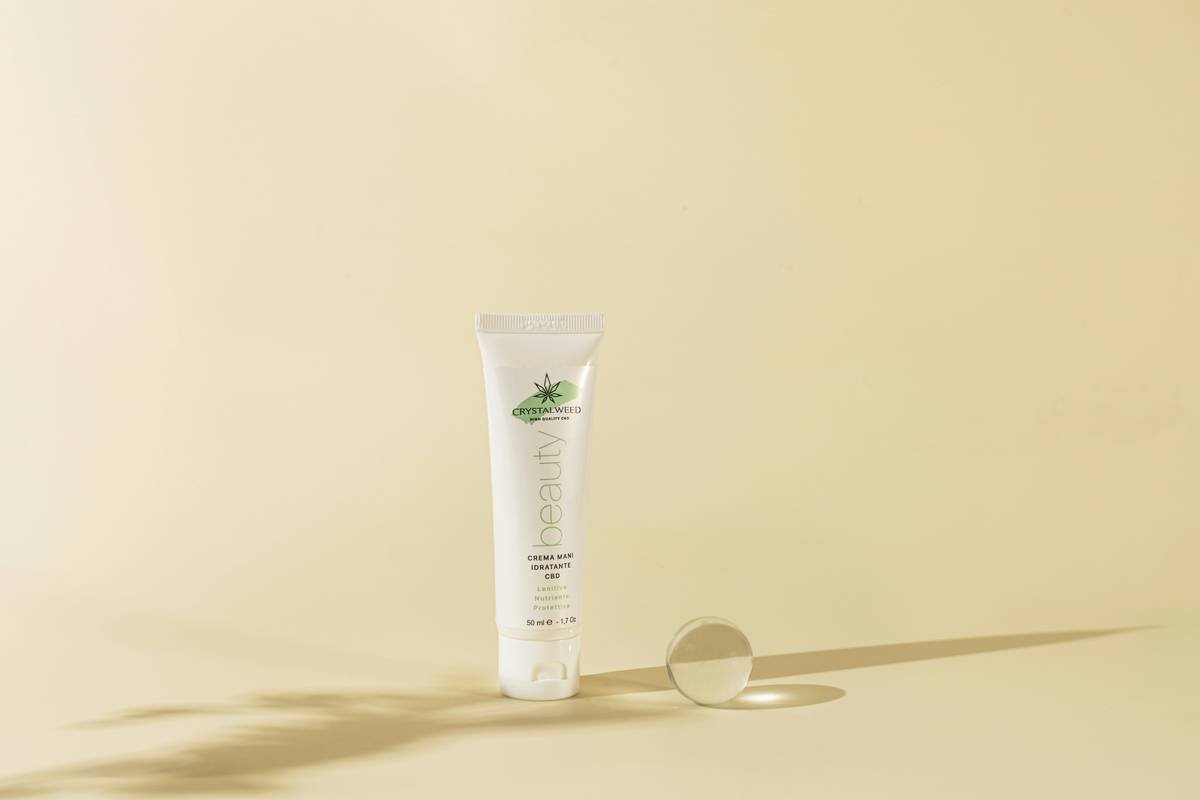 a white tube with a green label