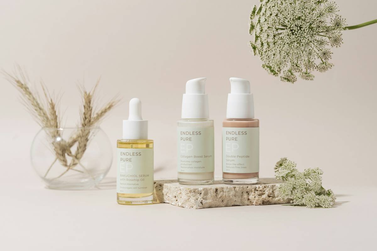 An elegantly organized collection of skincare products showcased on a marble tray, set against a soft beige backdrop. The minimalistic design and muted tones create a sophisticated and serene ambiance, highlighting the luxurious essence of the products.