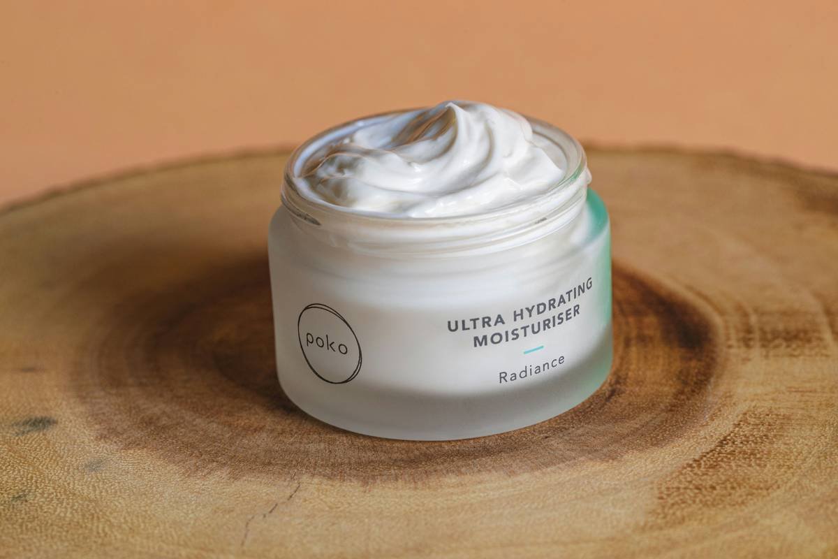 Moisturiser open on wooden plate
